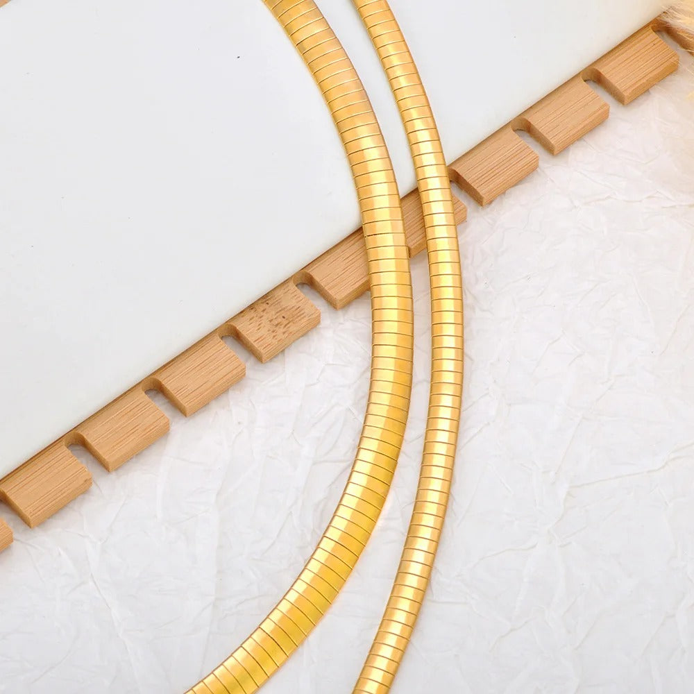 Gold snake-style cable on a white background