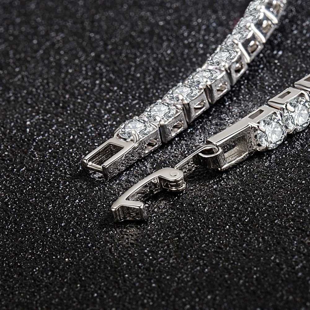 Close-up of a silver bracelet with clear stones on a dark textured background
