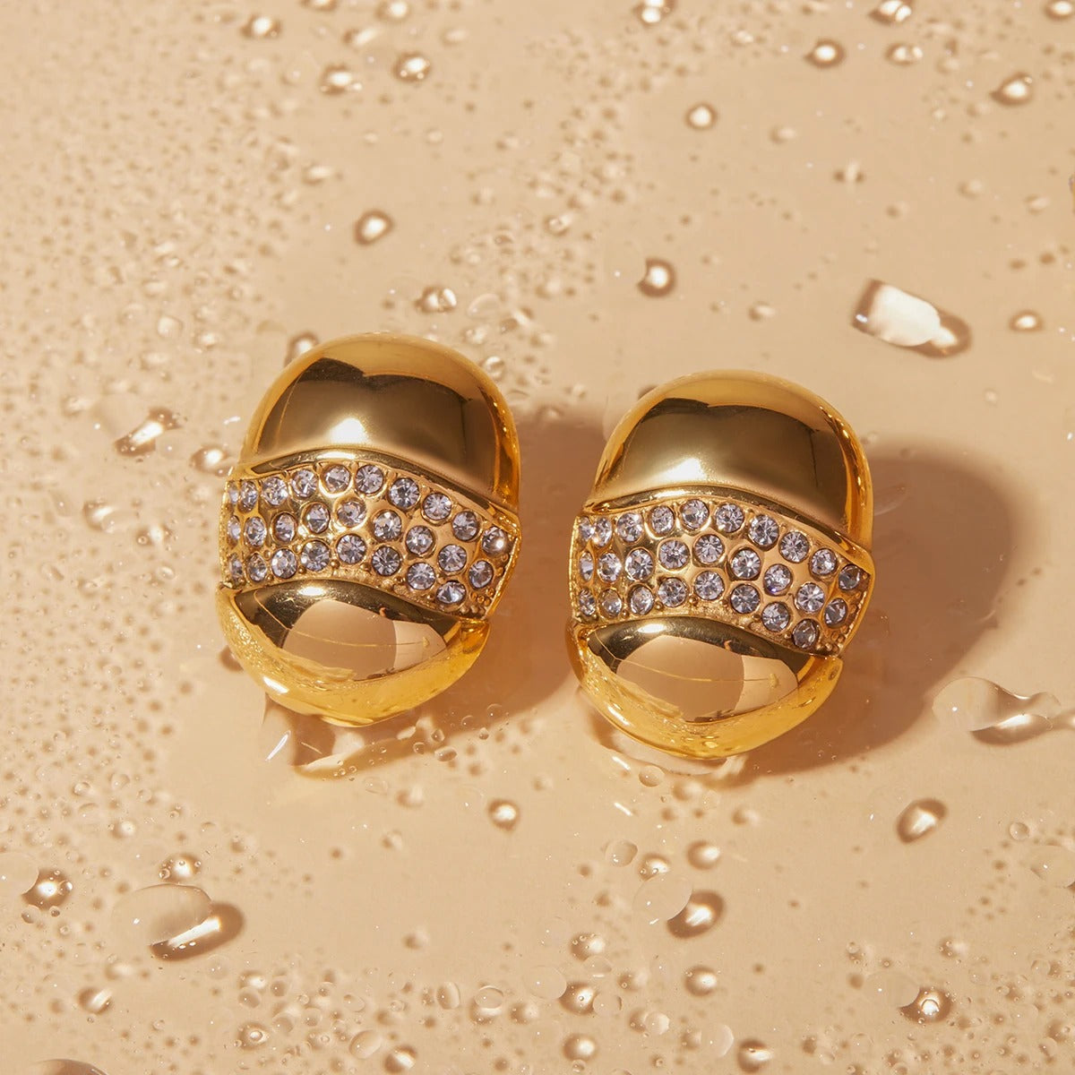 Trendy golden dome shaped earrings featuring rhinestone band, sophisticated fashion jewellery for women.