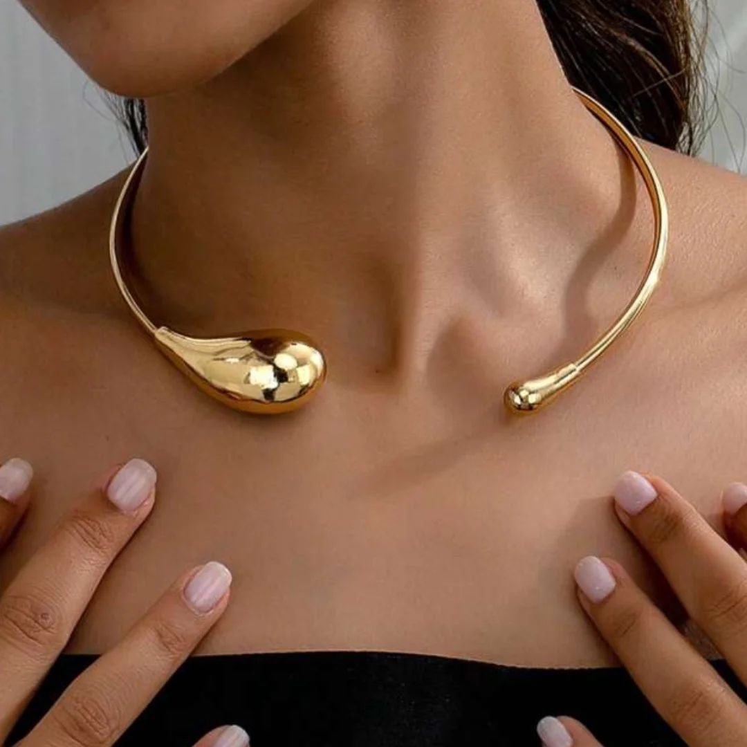 Statement gold choker necklace with bold teardrop ends, modern open design, elegant jewelry for parties & special occasions.