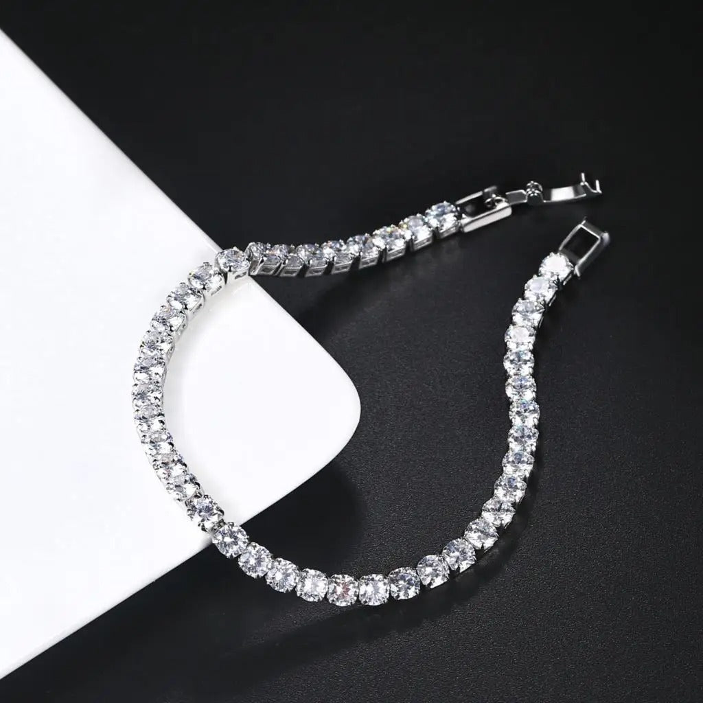 Elegant silver tennis bracelet featuring sparkling round cut stones, perfect for adding a touch of shine to any outfit.