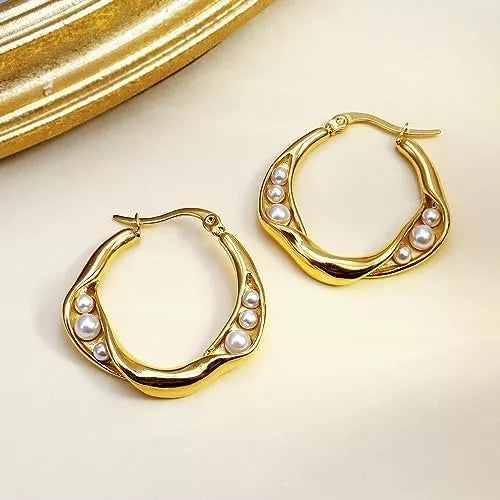 Elegant gold hoop earrings with pearl accents, blending timeless charm and luxury for a sophisticated modern style.