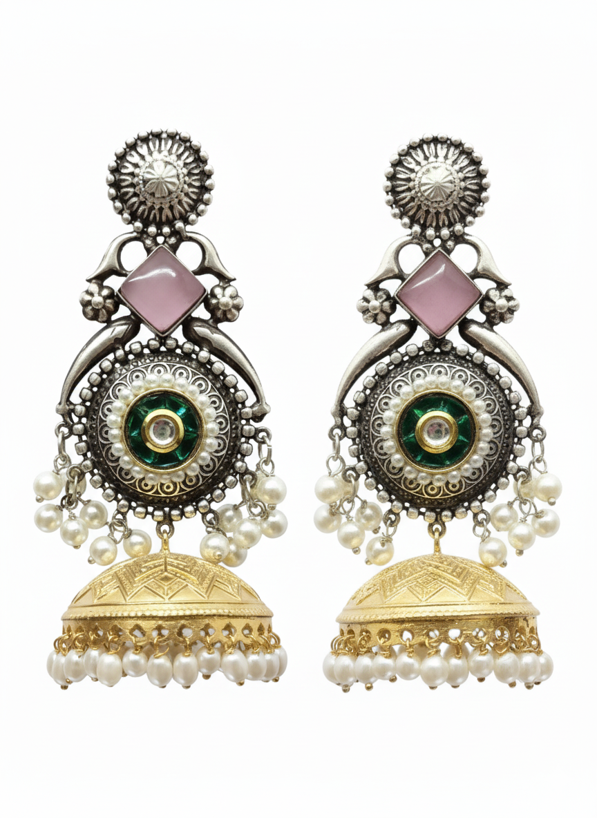 Ornate earrings with gold and silver details on a white background