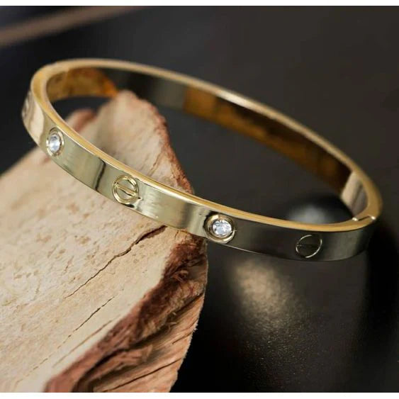 Gold bracelet with diamonds on a dark surface