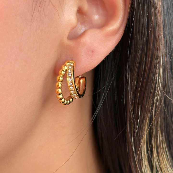 Woman wearing elegant golden beaded hoop earrings with studded stones, stylish jewelry for daily and festive wear.