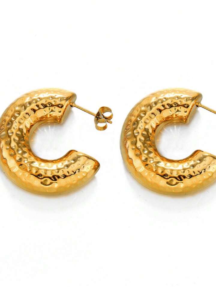 Gold hoop earrings with textured design on a white background