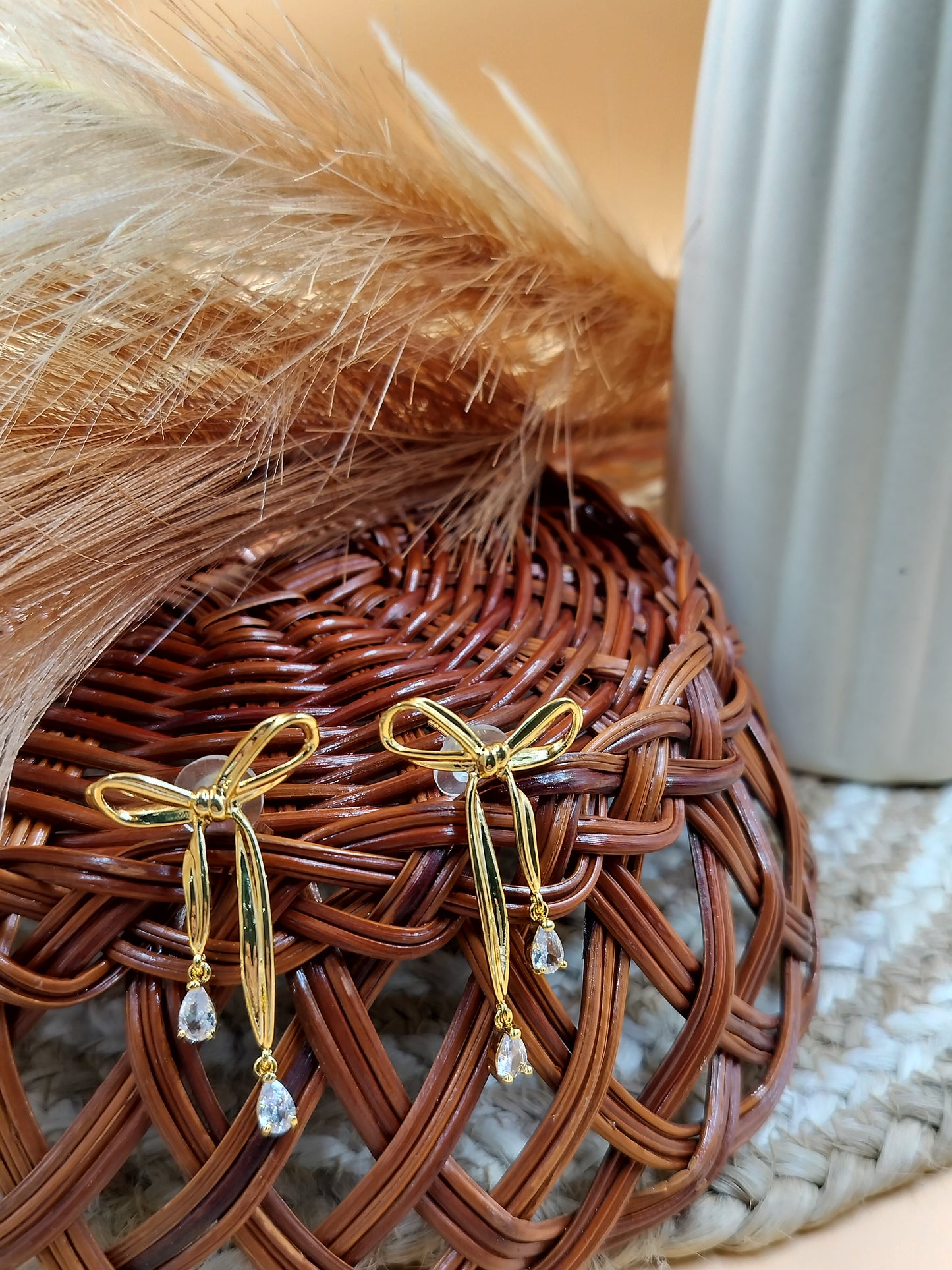 Trendy gold bow drop earrings with crystal danglers, lightweight anti-tarnish jewelry perfect for women’s parties and gifting.