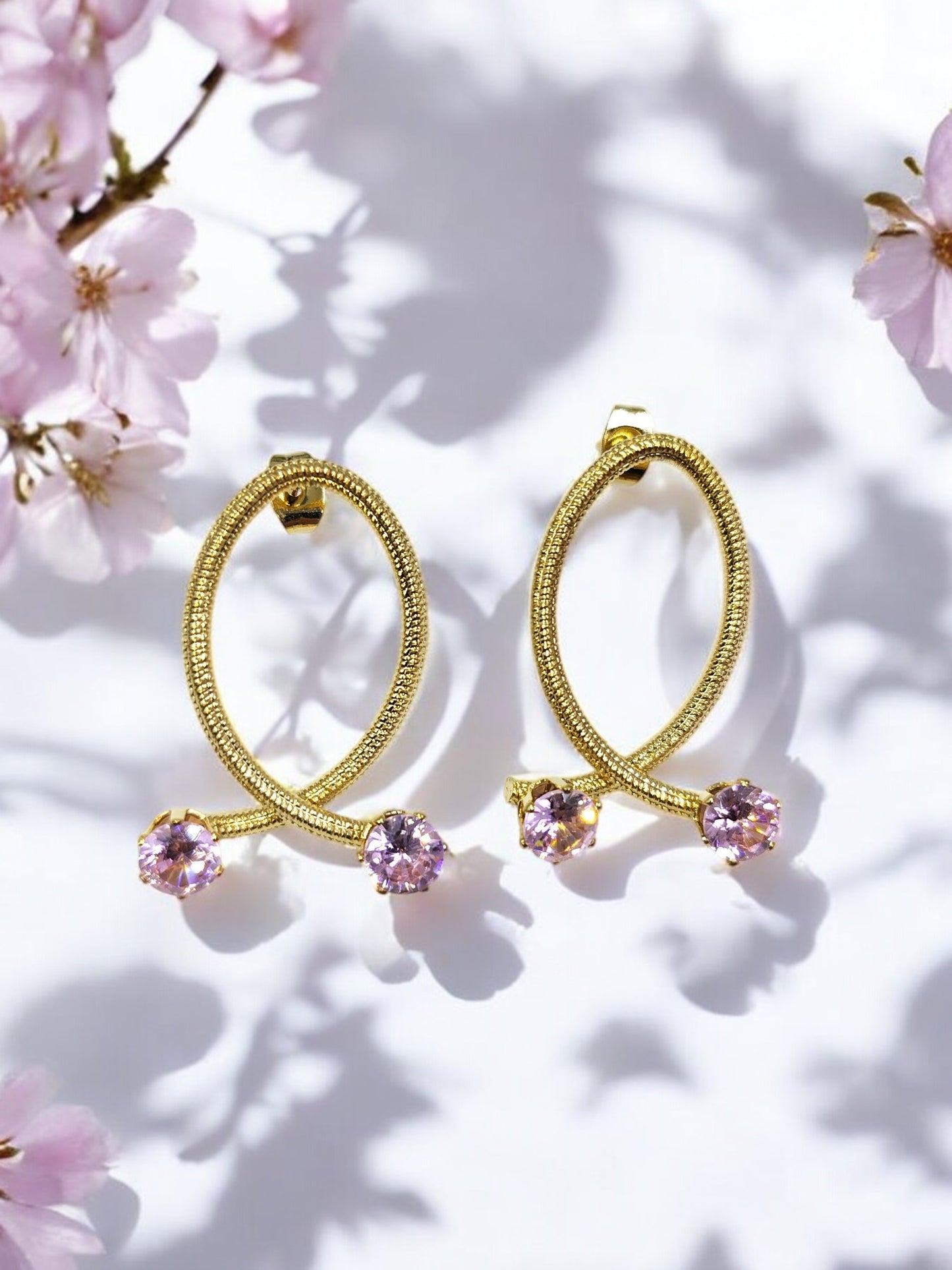 Elegant gold oval loop earrings with dual pink gemstones, perfect for weddings, parties and fashionable daily wear.