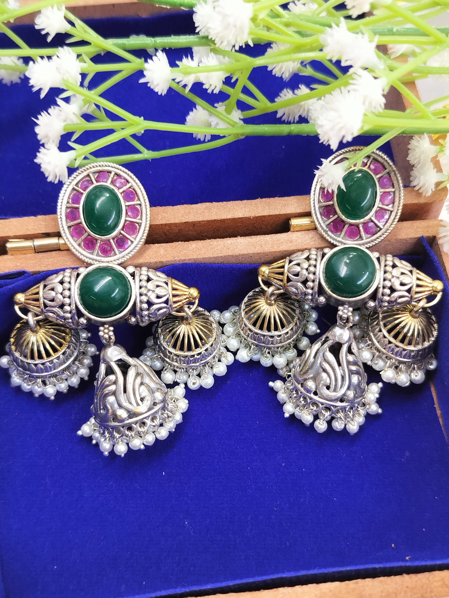 Bold, regal & festive – these green stone silver jhumkas are made to steal the spotlight.