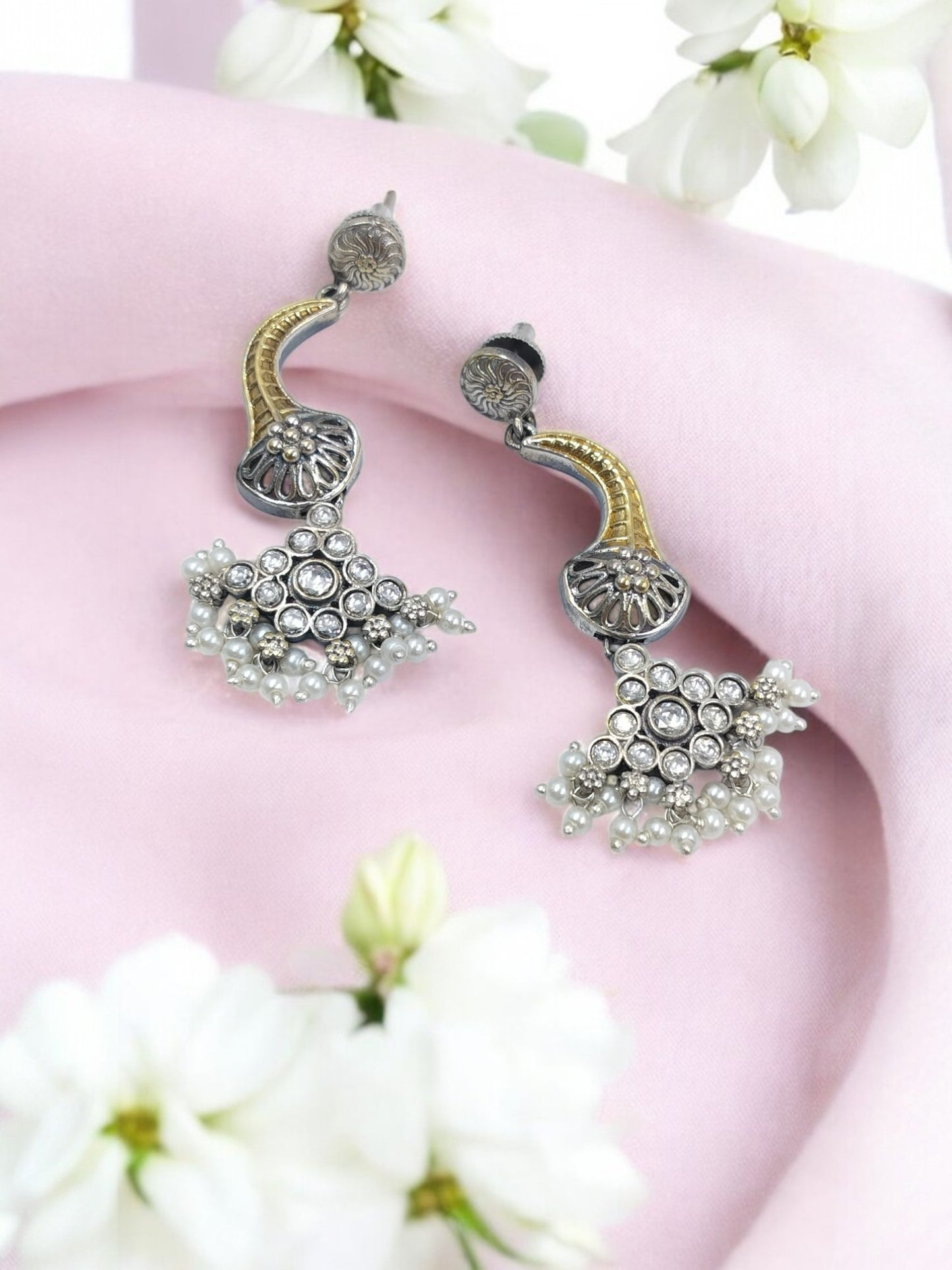 Charming oxidised dual-tone dangler earrings with sparkling stones, perfect for festive elegance.