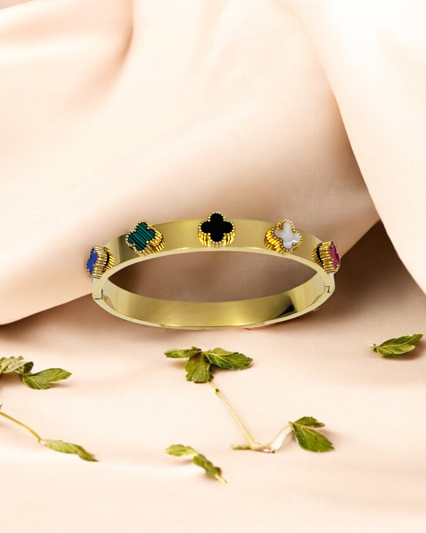 Elegant gold plated bangle bracelet with colorful clover motifs, trendy statement jewelry perfect for women’s festive style.