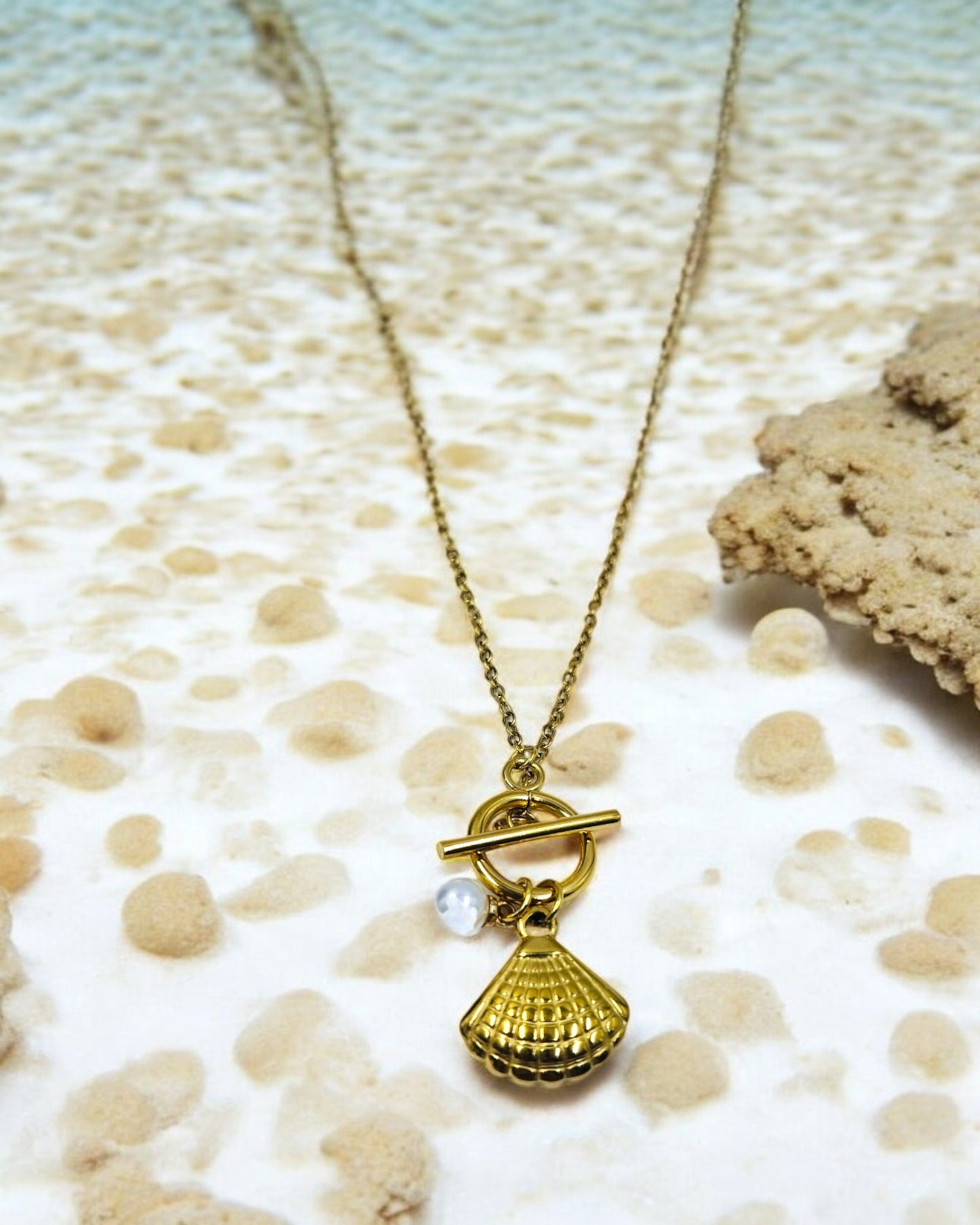 Gold plated seashell pendant necklace with pearl charm, trendy beach style jewelry perfect for vacations and summer wear.