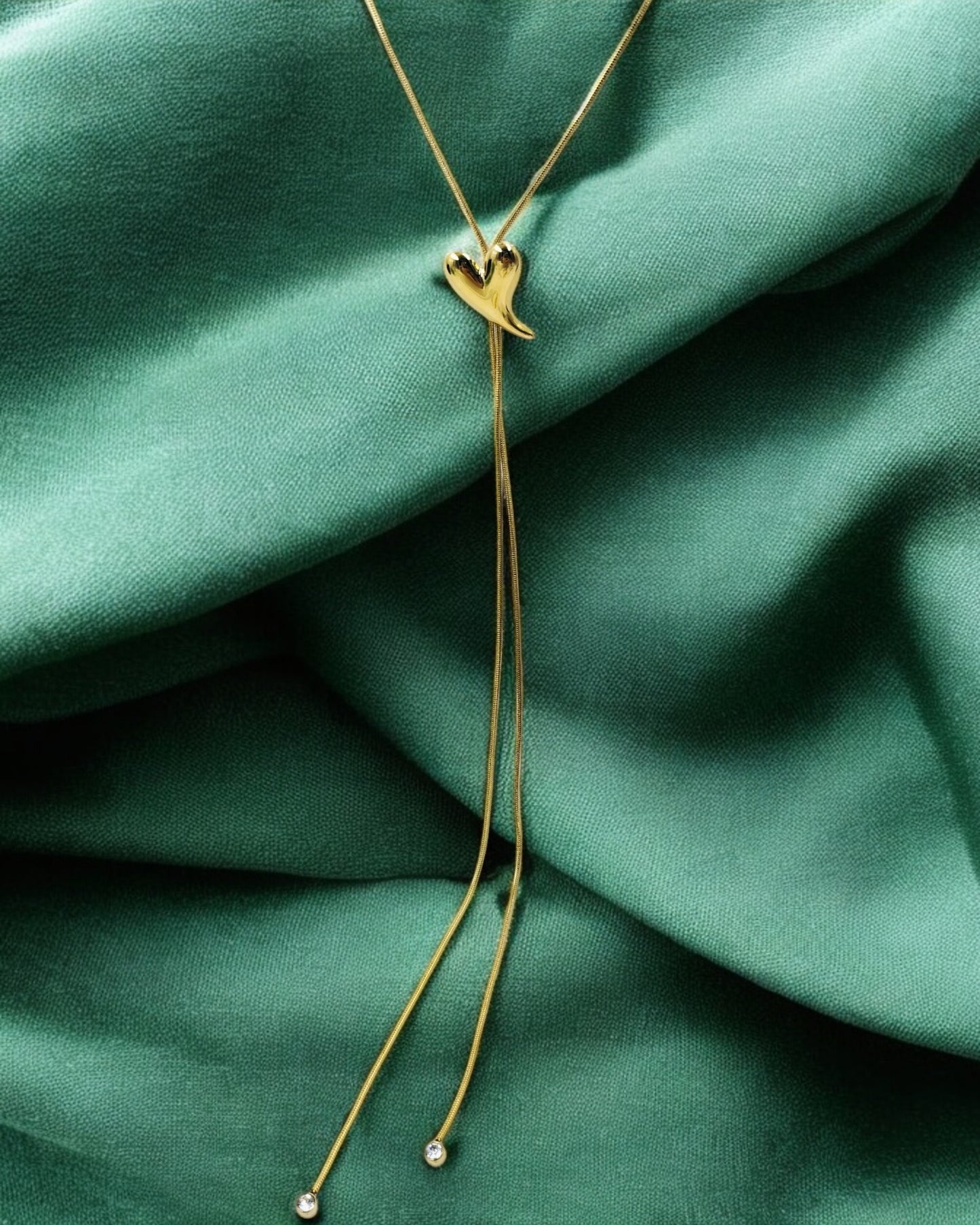 Elegant gold heart pendant lariat necklace with adjustable chain and crystal ends, minimal romantic jewelry for women.