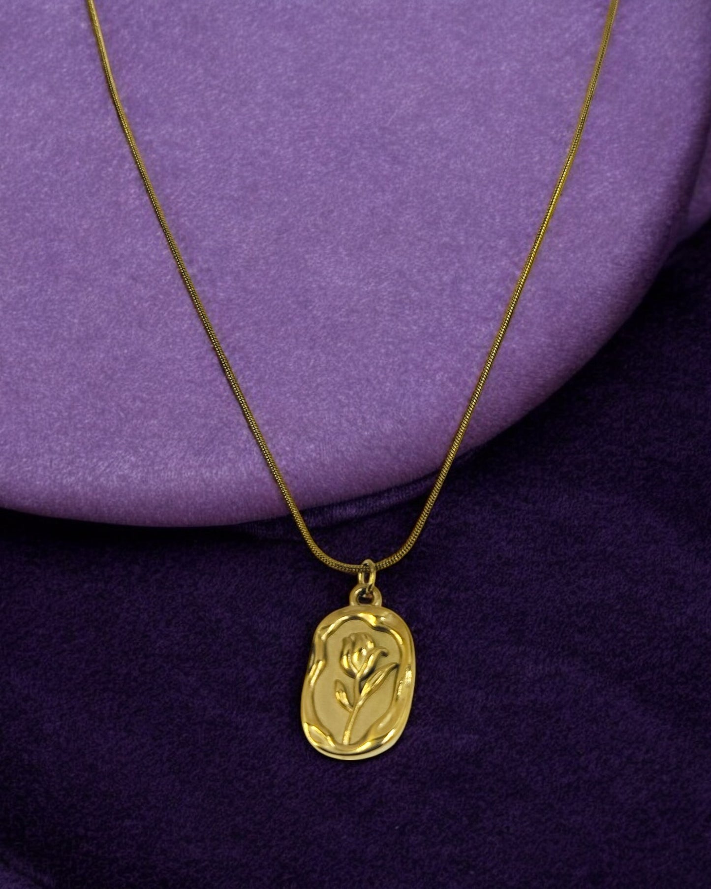 Gold pendant necklace with embossed rose flower design, elegant minimal jewelry for women.