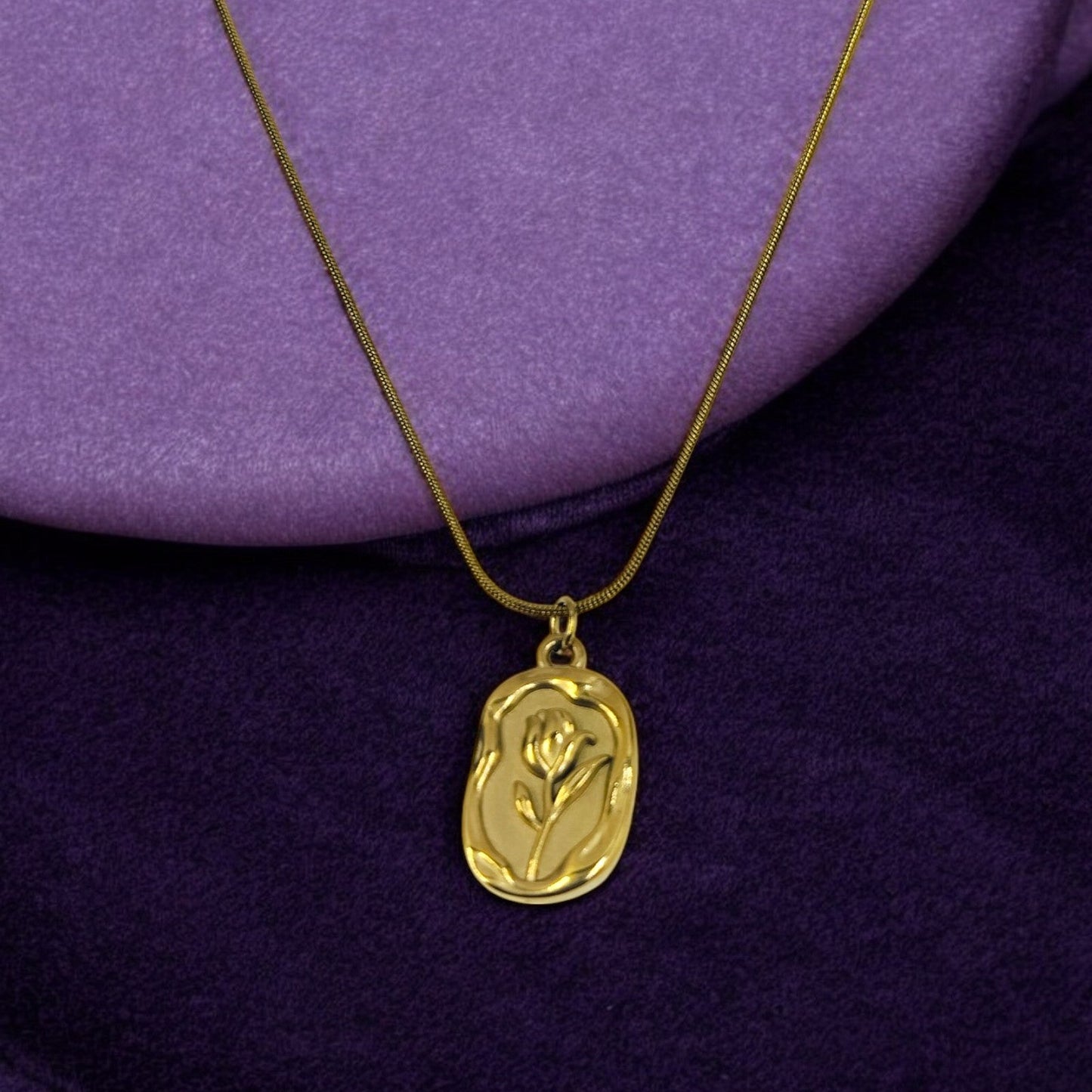 Gold pendant necklace with embossed rose flower design, elegant minimal jewelry for women.