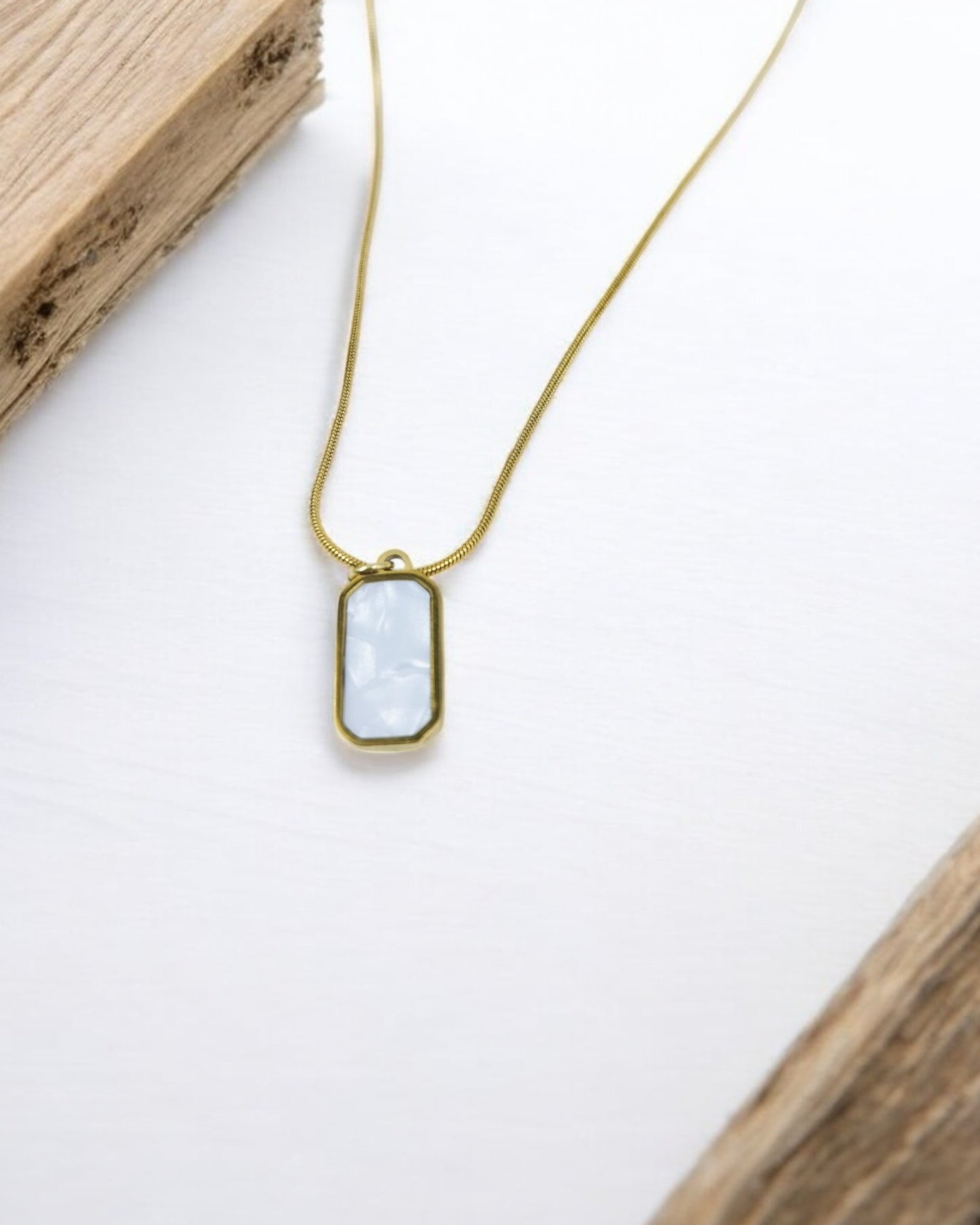 Minimalist gold chain necklace with rectangular white stone pendant, modern everyday jewelry for women.