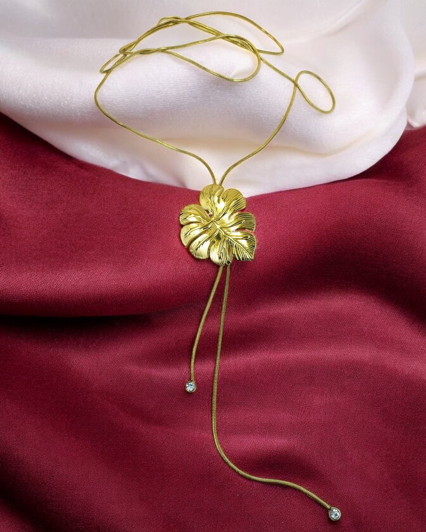 Elegant gold floral pendant necklace with adjustable long chain and crystal drops, statement jewelry for parties and special occasions.