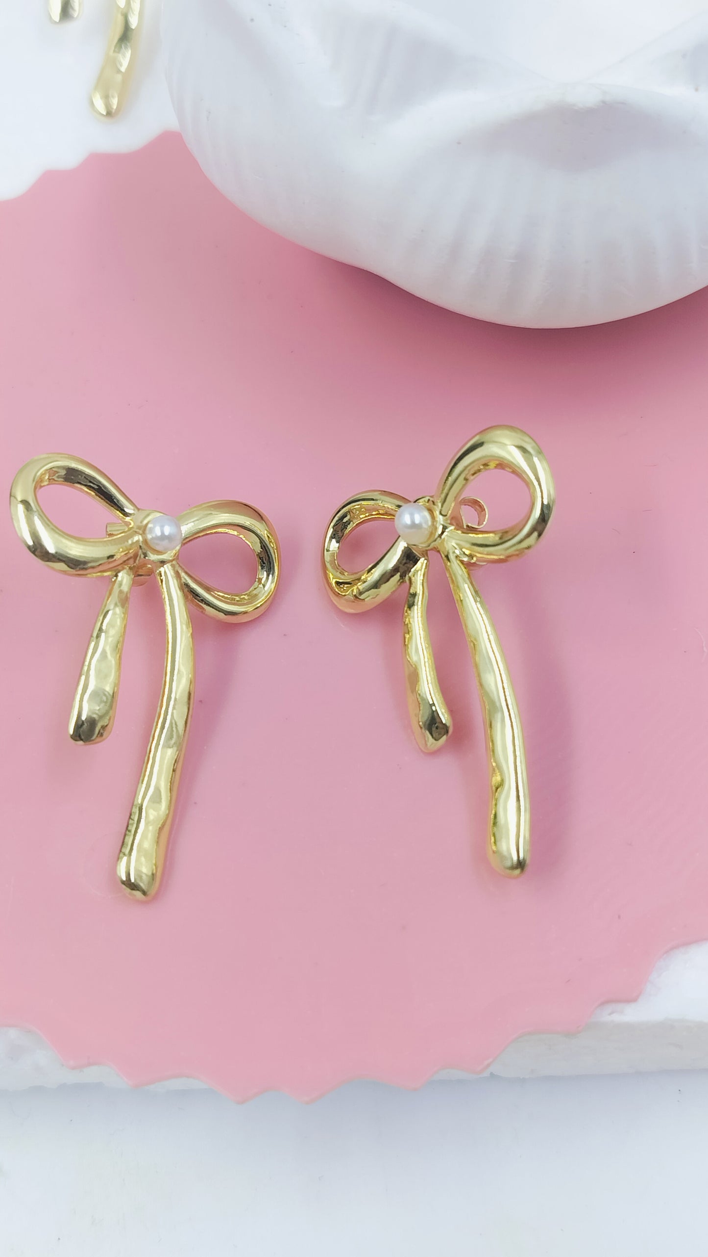 Chic gold bow stud earrings with pearl accents, feminine and stylish design perfect for everyday wear or gifting.
