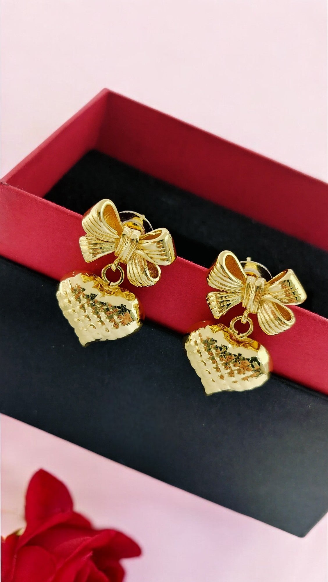 Charming gold bow and heart dangle earrings, perfect gift for women, stylish festive and romantic jewelry.