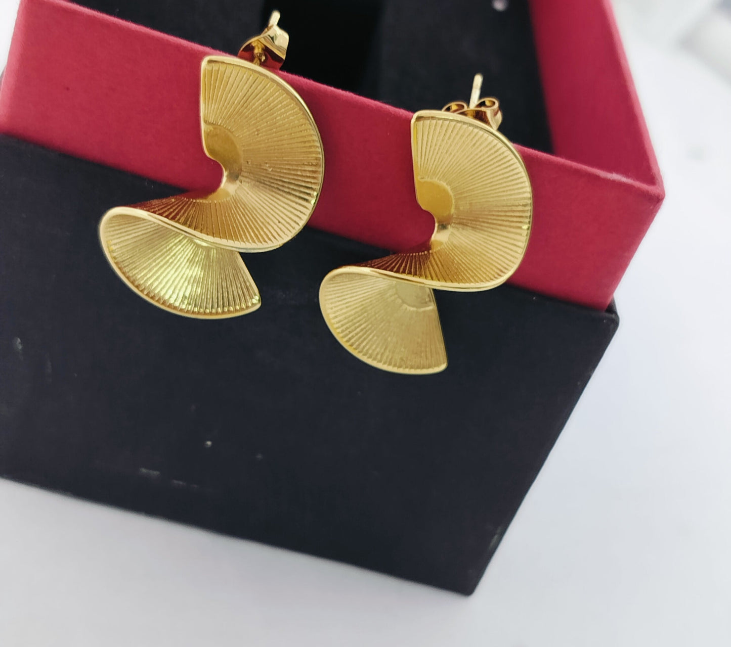 Modern gold spiral stud earrings with textured design, elegant fashion jewelry in gift box