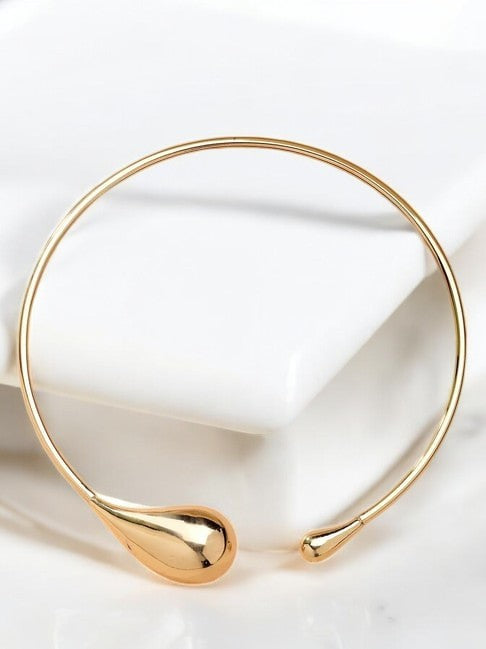 Minimalist gold choker necklace with sleek open design and bold teardrop ends, modern statement jewelry for women.