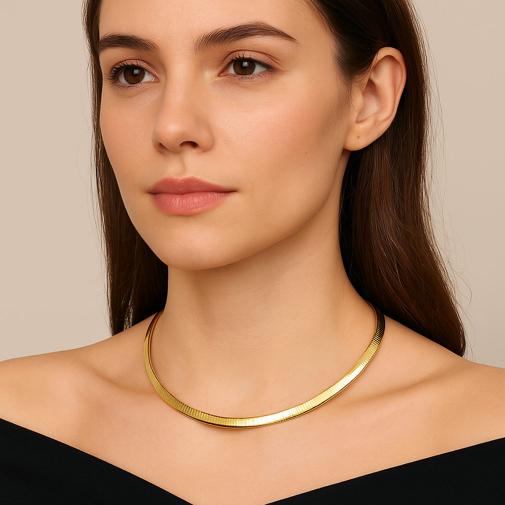 Woman wearing elegant gold choker necklace with sleek flat design, styled with an off-shoulder black dress.