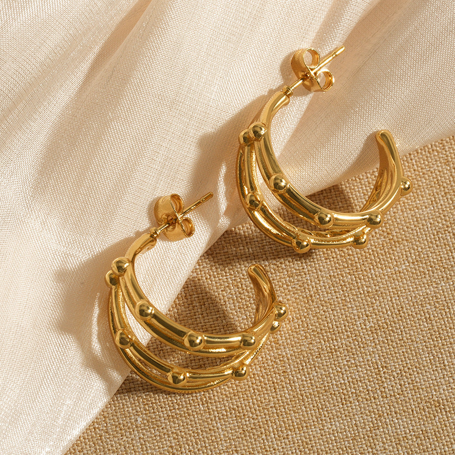 Elegant gold hoop earrings with layered crescent design, modern statement jewelry for parties and festive occasions