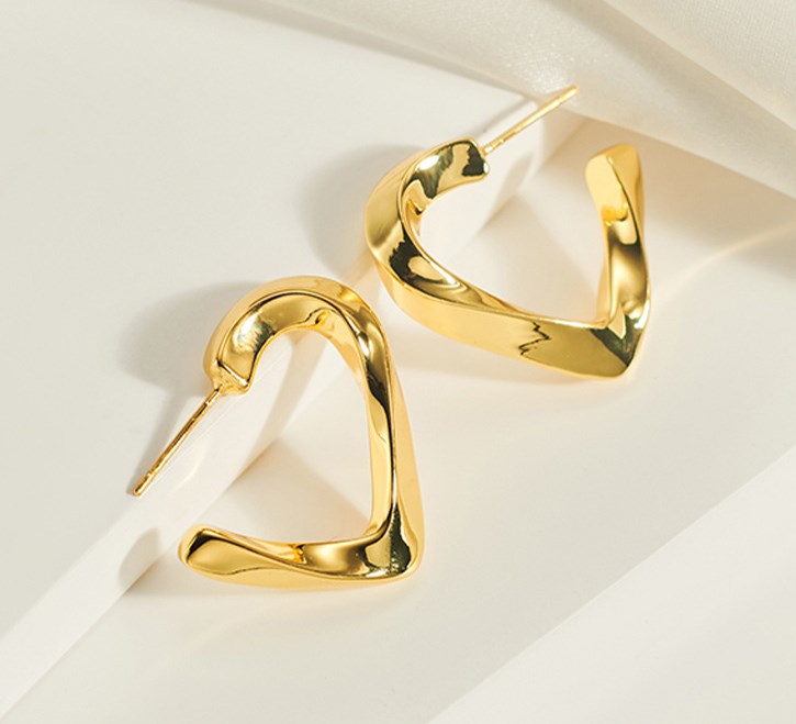 Trendy gold heart-shaped earrings displayed on white background, elegant lightweight jewelry for women’s daily and party wear.