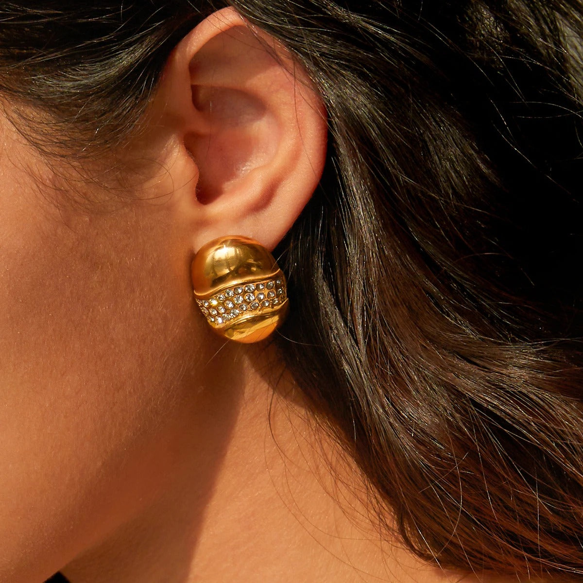 Golden dome diamond studded luxe earrings with wave rhinestone design, bold modern women jewellery for party wear.