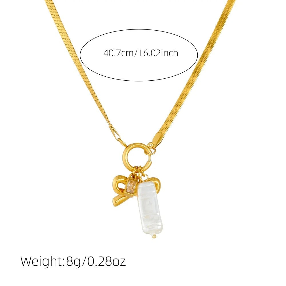 Gold necklace with a bow and rectangular pendant on a white background