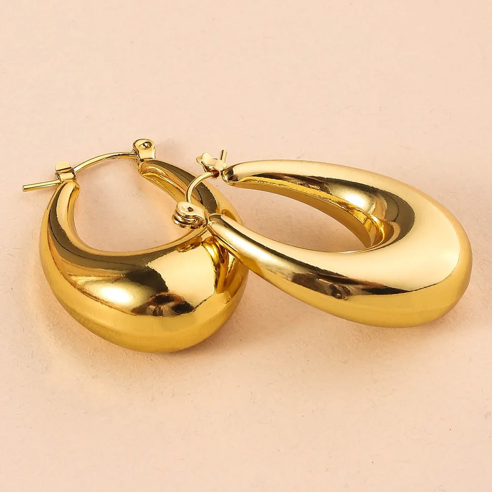 Classic gold oval hoop earrings for women, elegant fashion jewellery perfect for daily wear, party look & gifting.