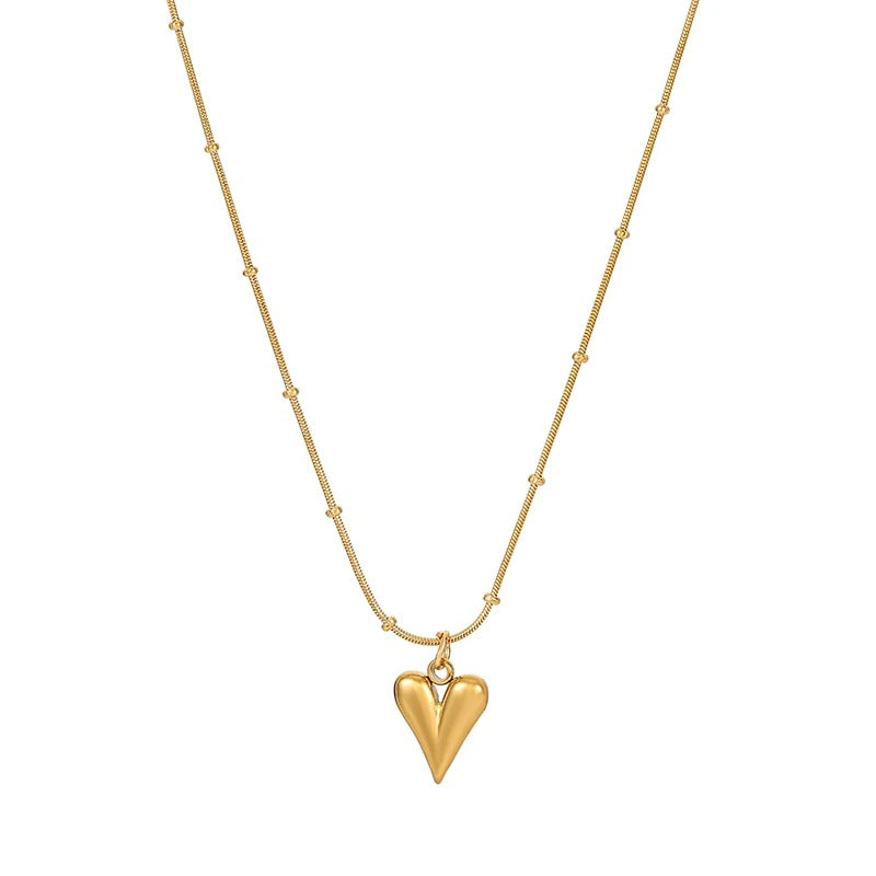 Minimalist gold necklace with heart-shaped pendant and beaded chain.