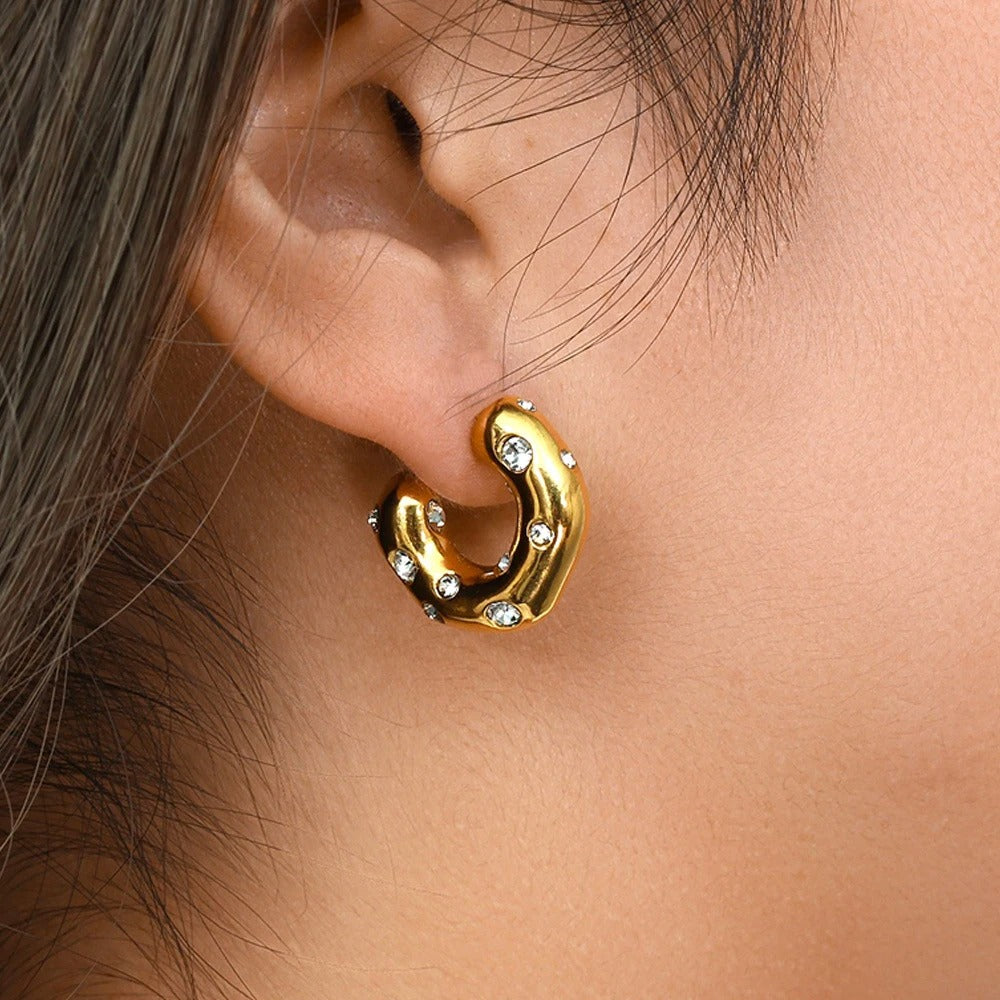 Stylish molten-inspired golden C shape earrings studded with diamonds, elegant fashion jewellery for women.