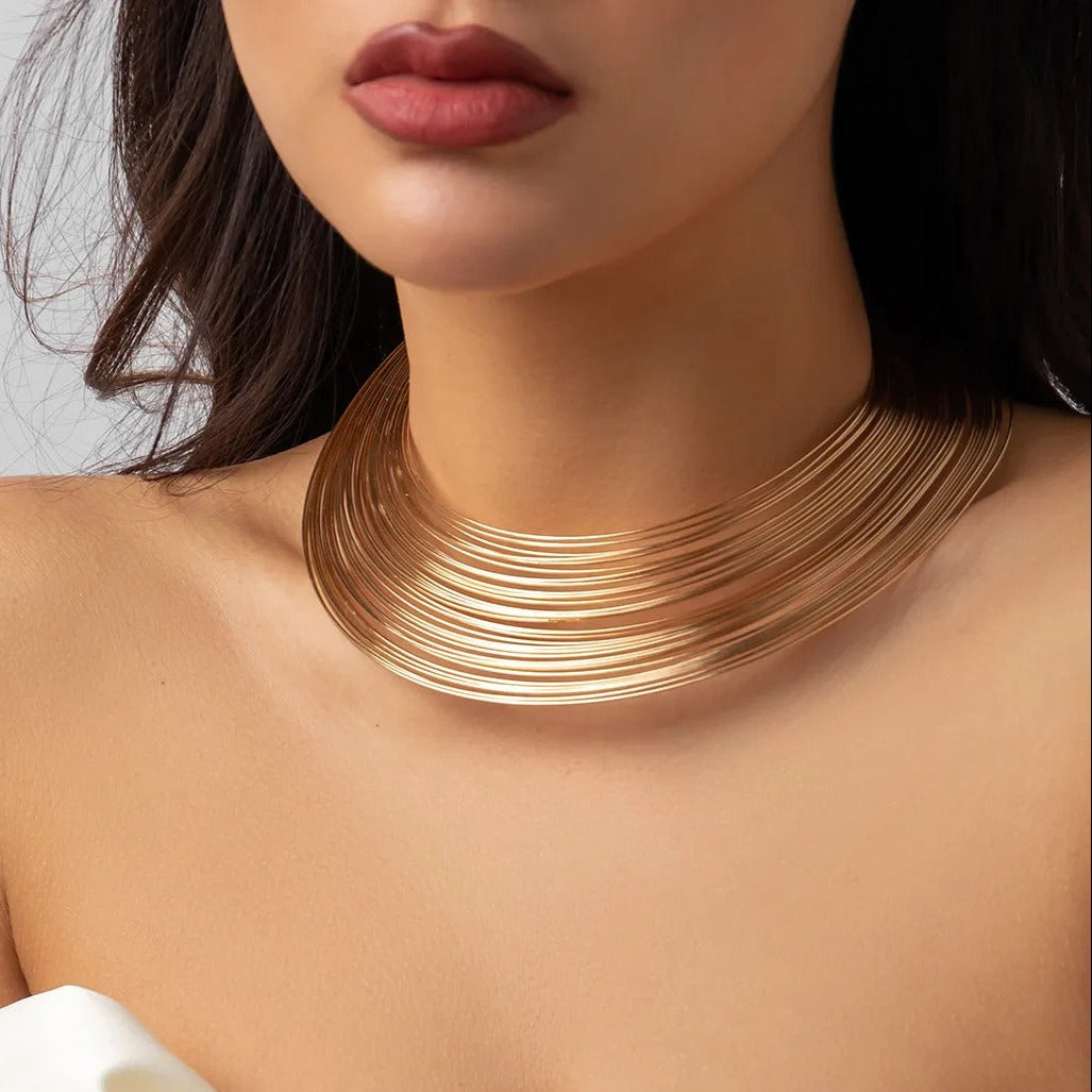 Model wearing elegant layered gold plated choker necklace with off shoulder dress – Glampouch jewelry