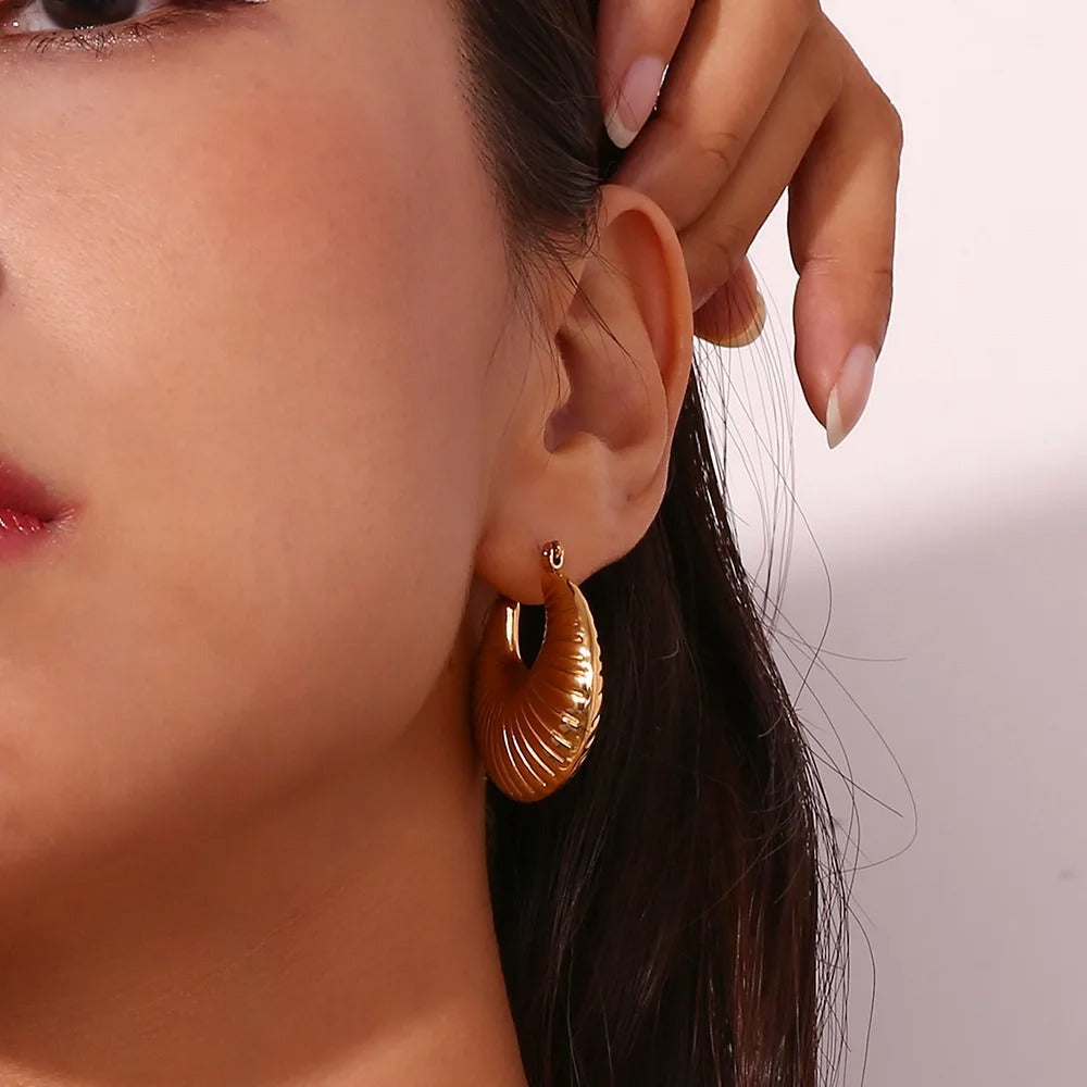 Trendy gold hoop earrings worn by woman, stylish textured design for daily wear and party fashion jewelry