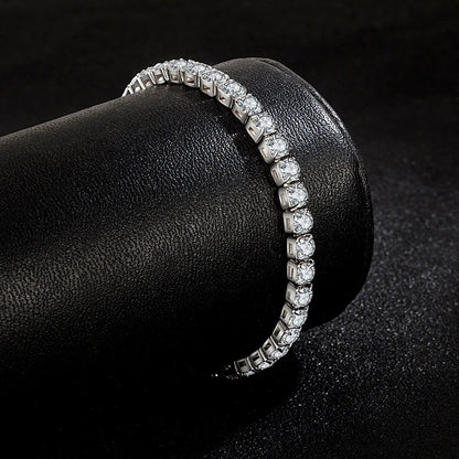 Elegant silver tennis bracelet with sparkling round stones displayed on a black leather roll.