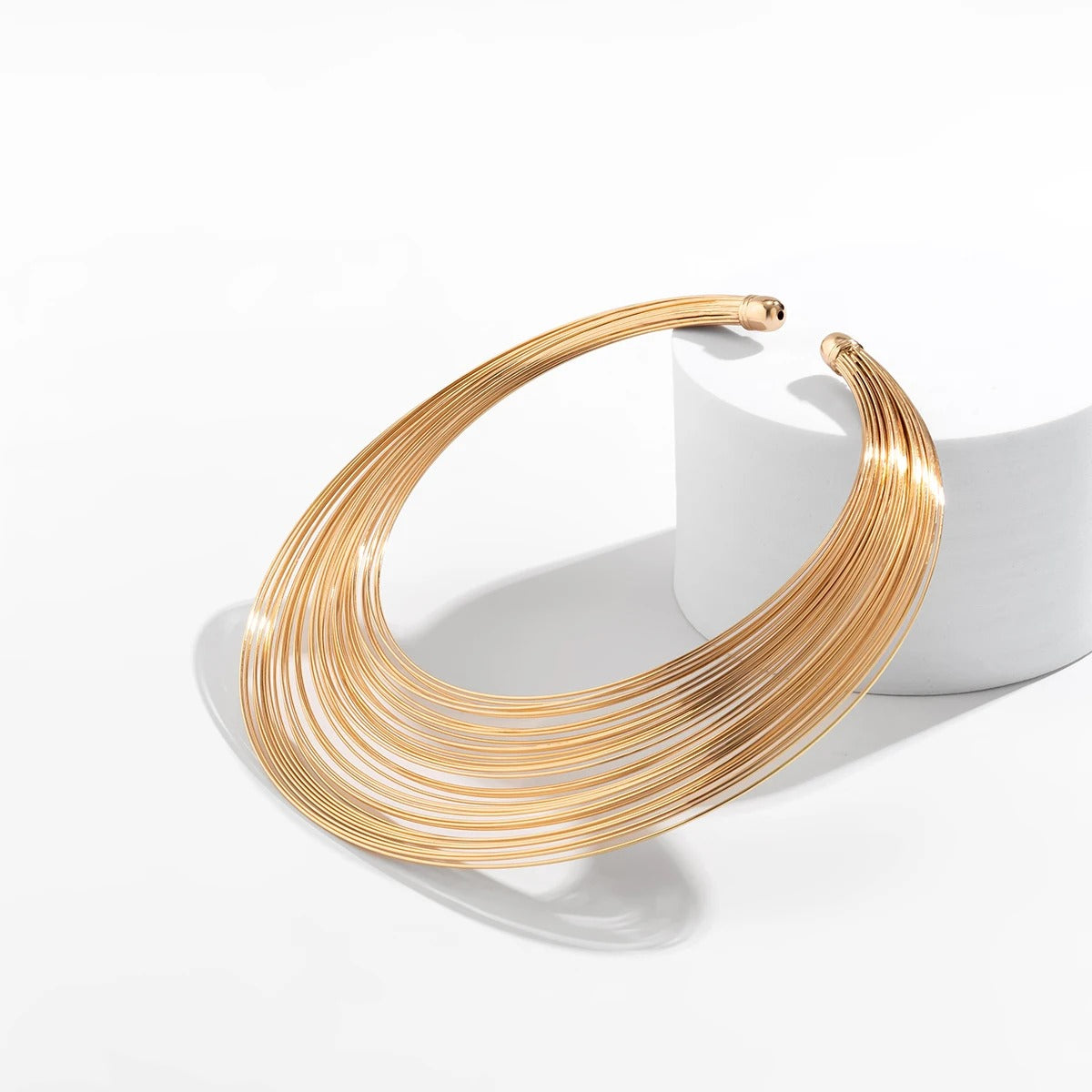 Elegant layered gold plated choker necklace displayed on white background – Glampouch jewelry