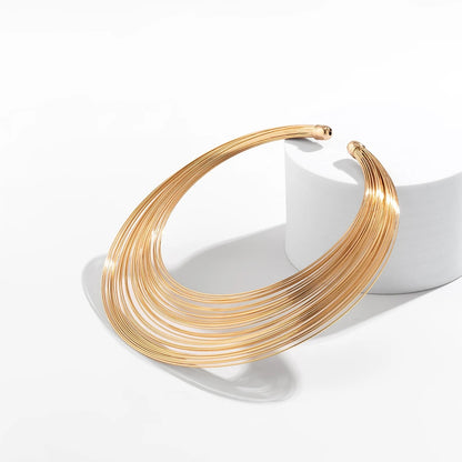 Elegant layered gold plated choker necklace displayed on white background – Glampouch jewelry