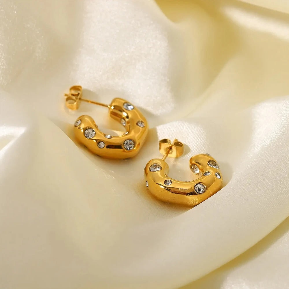 Modern sculptural gold hoop earrings with cubic zirconia sparkle, bold luxe jewellery perfect for gifting.