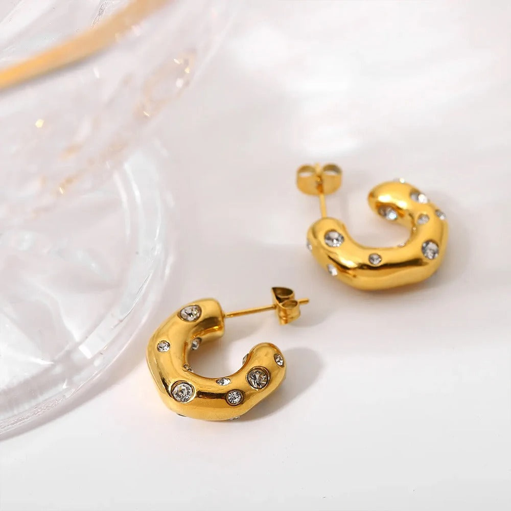 Golden C shape diamond studded luxe earrings, molten design with sparkling stones for bold modern women jewellery.