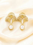 Pair of gold-plated ginkgo fan drop earrings with white faux-pearl drops on cream satin