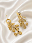 Side view of gold leaf drop earrings showing post-back fitting and textured leaf detail on satin
