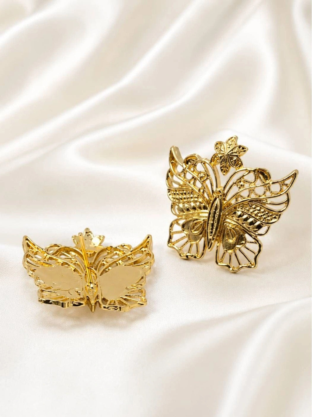 Front and back view of gold butterfly earrings showing push-back closure on satin