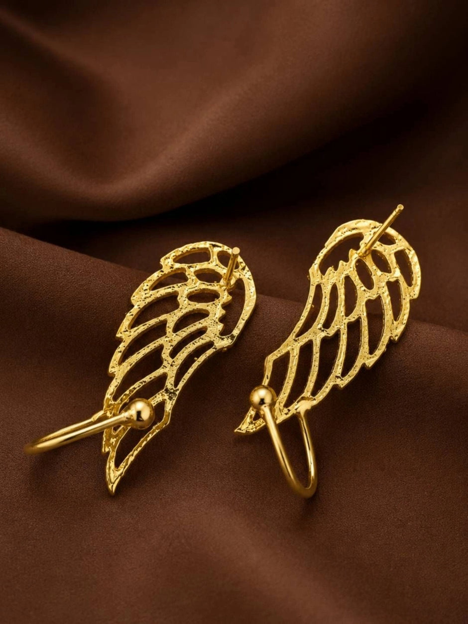 Back view of two gold angel wing ear cuffs showing double-wire fitting and ball-end pins on brown fabric