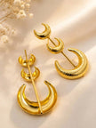 Back view of gold-plated crescent moon earrings showing stud post mechanism on satin surface