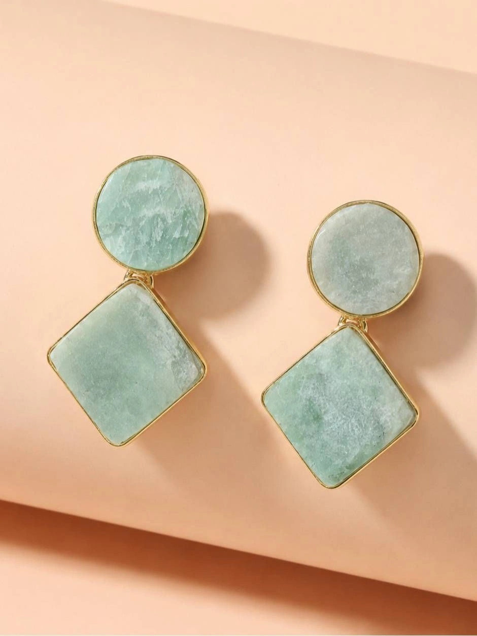 Pair of mint green amazonite geometric drop earrings with gold bezel on a peach surface