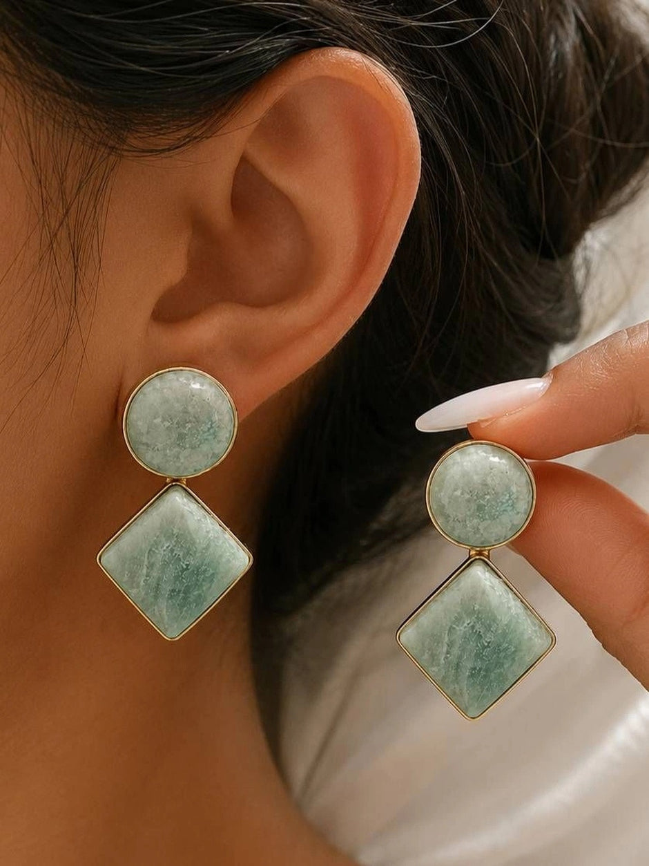 Model wearing mint green amazonite circle and diamond drop earrings on one ear