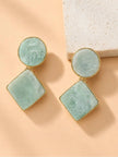 Both amazonite geometric drop earrings laid flat beside a white stone surface