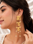 Woman wearing one gold-plated Hindi bride script drop earring showing full length against her ear and neck