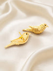 Front and back view of gold bird stud earrings on white satin showing stud post and black eye detail